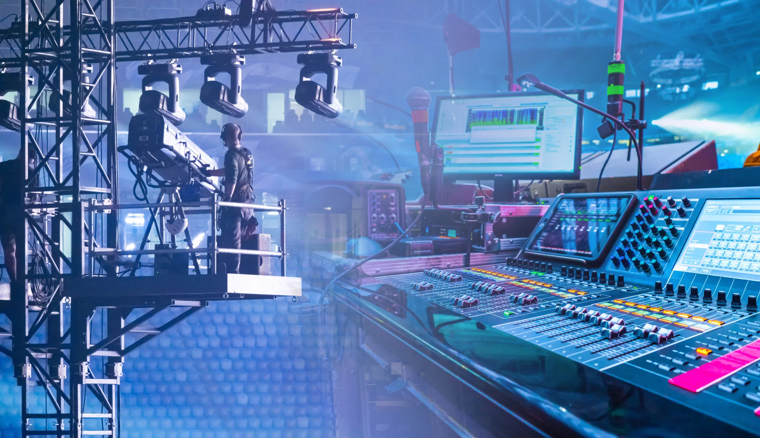 Concert or live event production with lighting rig, camera operator, sound mixing console