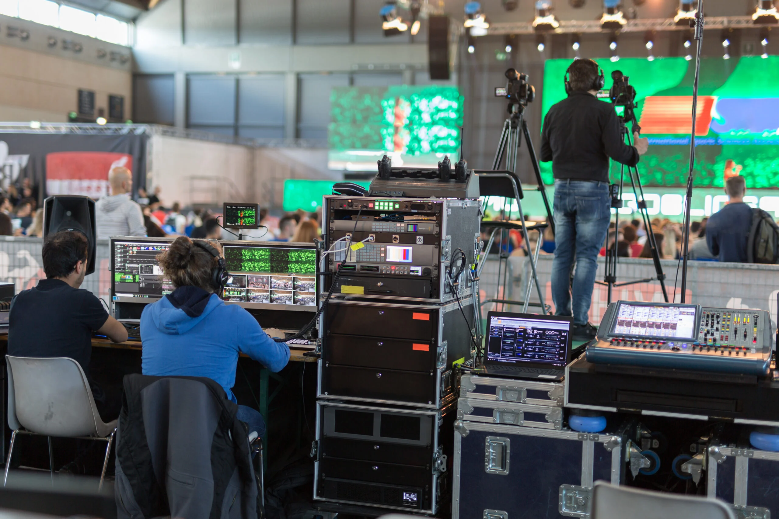 Lighting and sound technicians and television operators at work in the backstage during a public