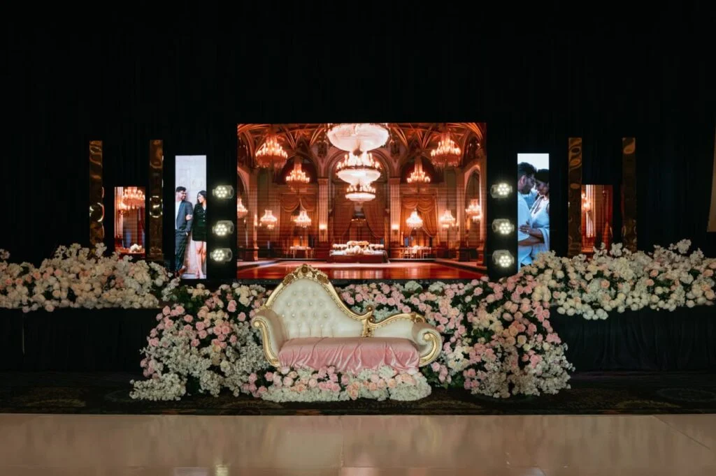 Wedding reception stage with an LED video wall backdrop and LED columns by Unity Logics