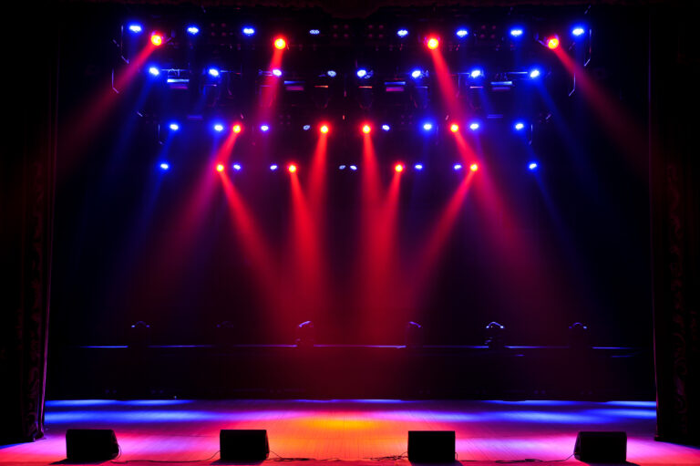 Stage with red and white moving light beams